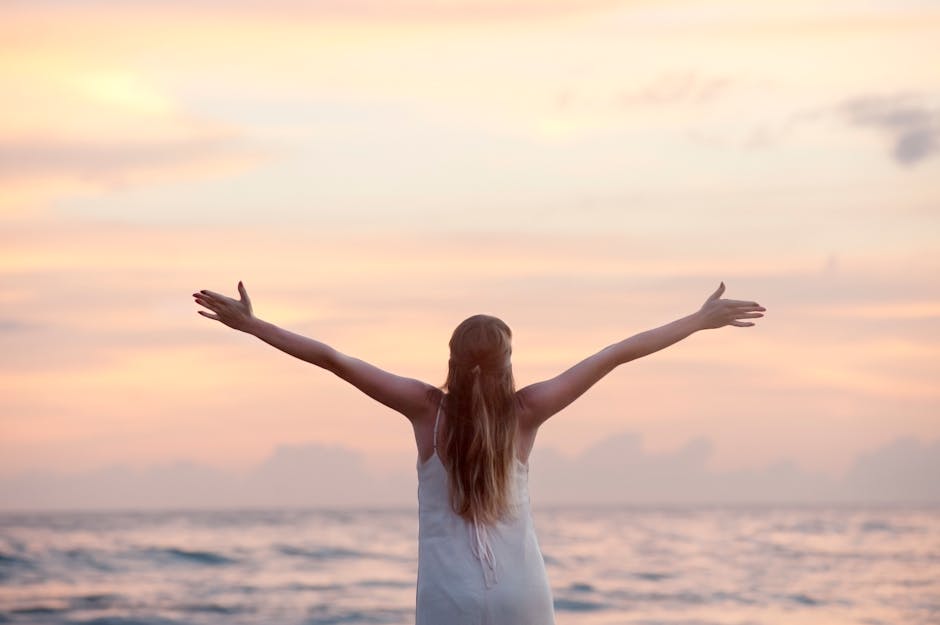 A woman enjoying a serene sunset on Unawatuna Beach, Sri Lanka, depicting peace and freedom